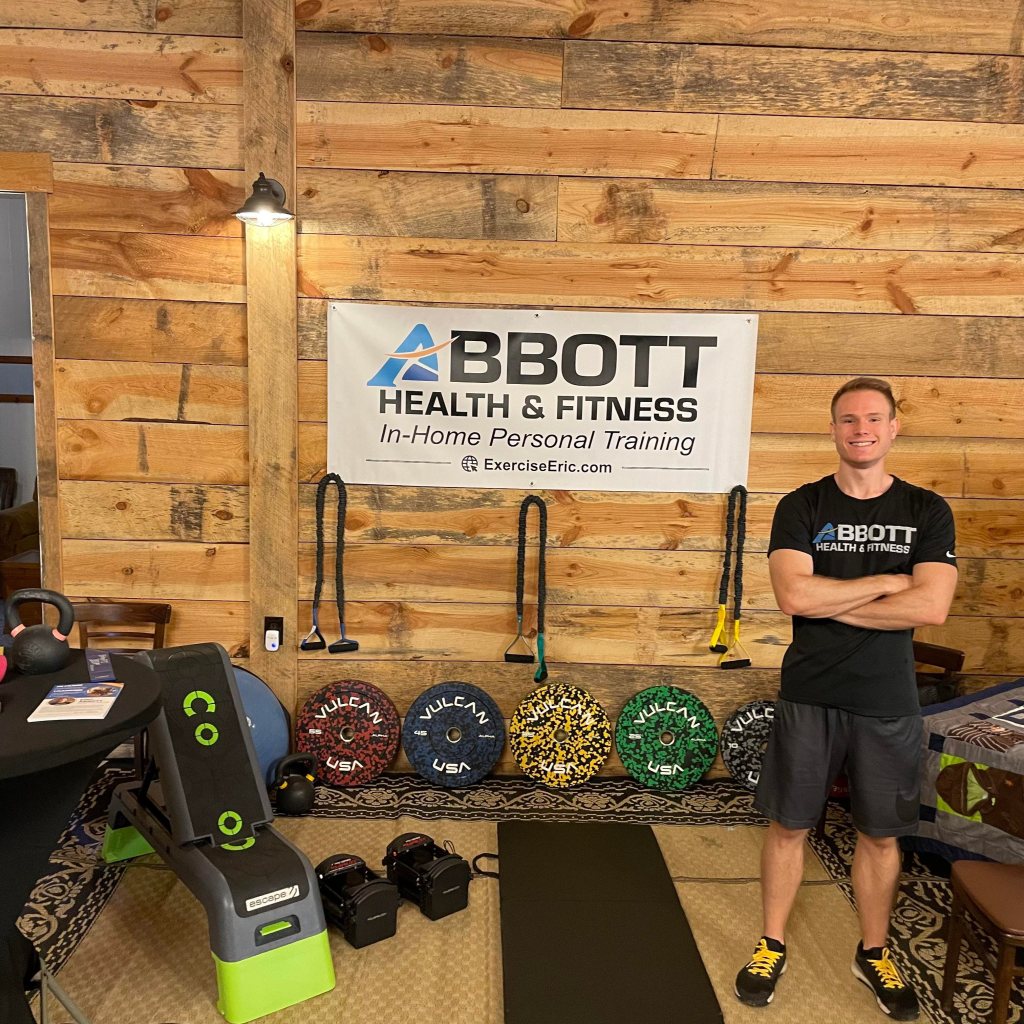 Eric Abbott of Abbott Fitness in his booth set up for Christmas in July at 3 Oaks Farms